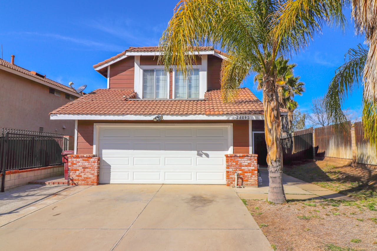 brown house and palm trees