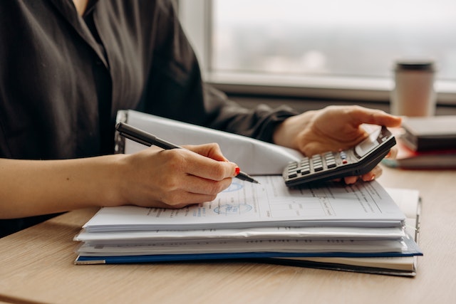 person doing calculations for taxes