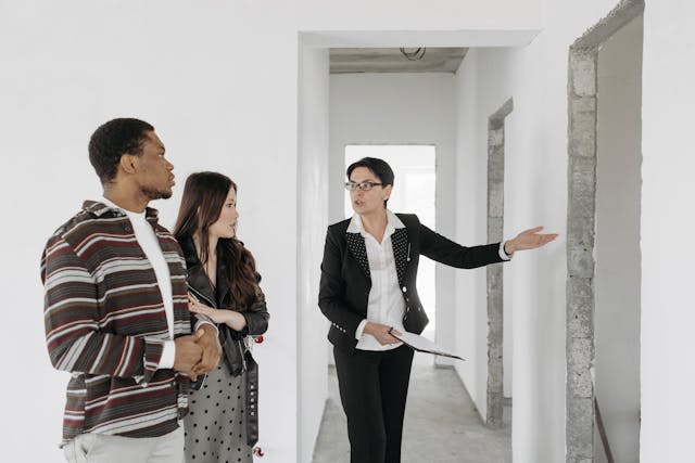 person showing two people white walls in house